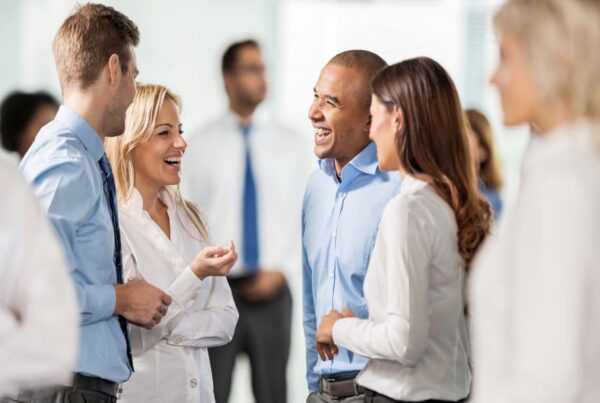 four people talking in a group networking