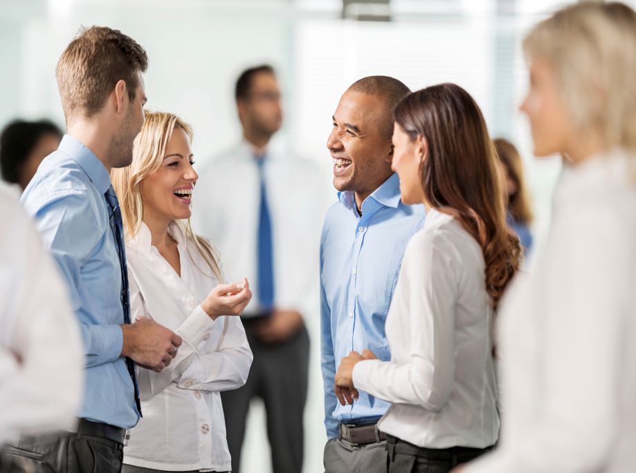 four people talking in a group networking